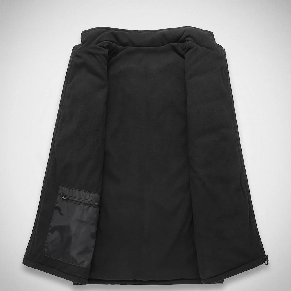 Intérieur du gilet chauffant : doublure polaire noire et poche zippée pour la batterie