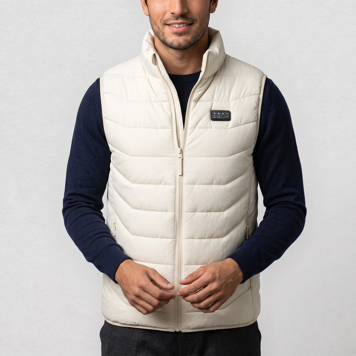 Gilet chauffant blanc cassé porté par un homme en pull marine