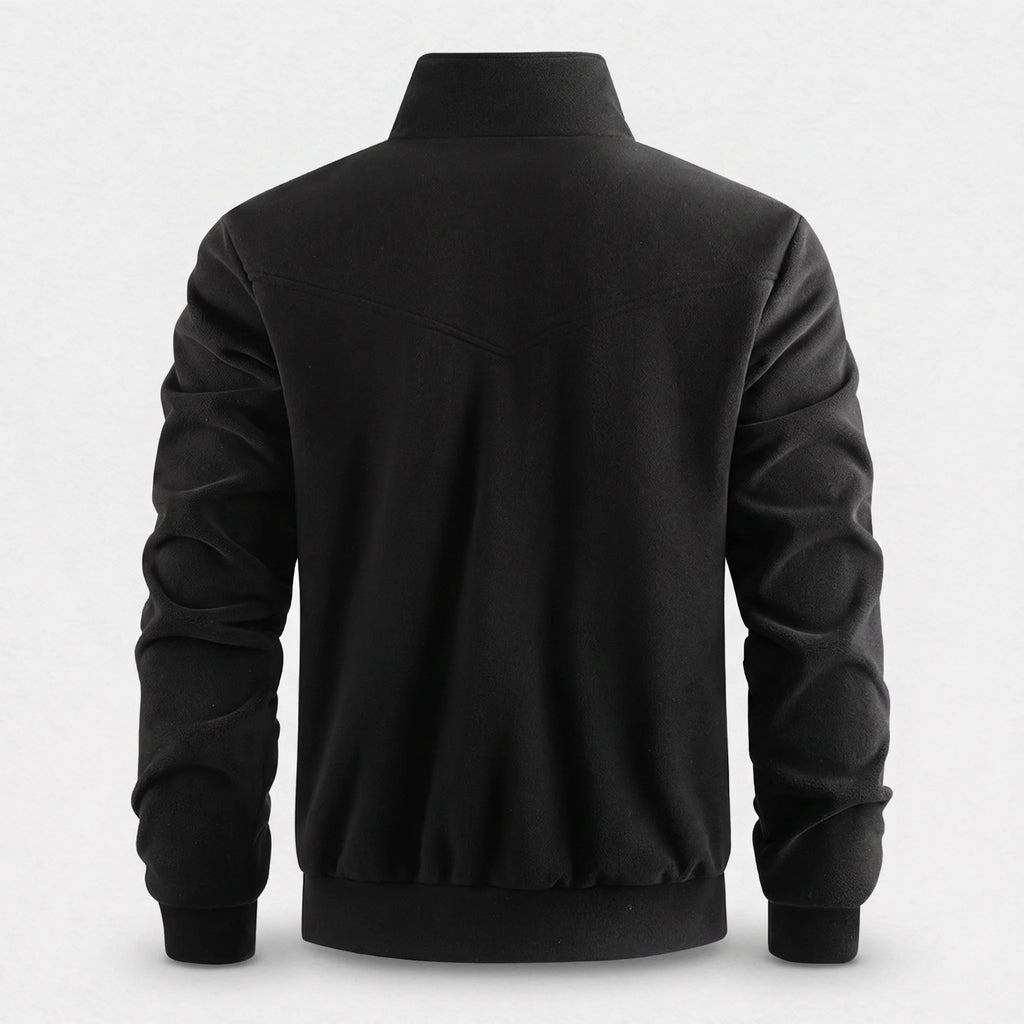 Dos de la veste polaire chauffante noire, empiècement courbe et bas en bord-côte