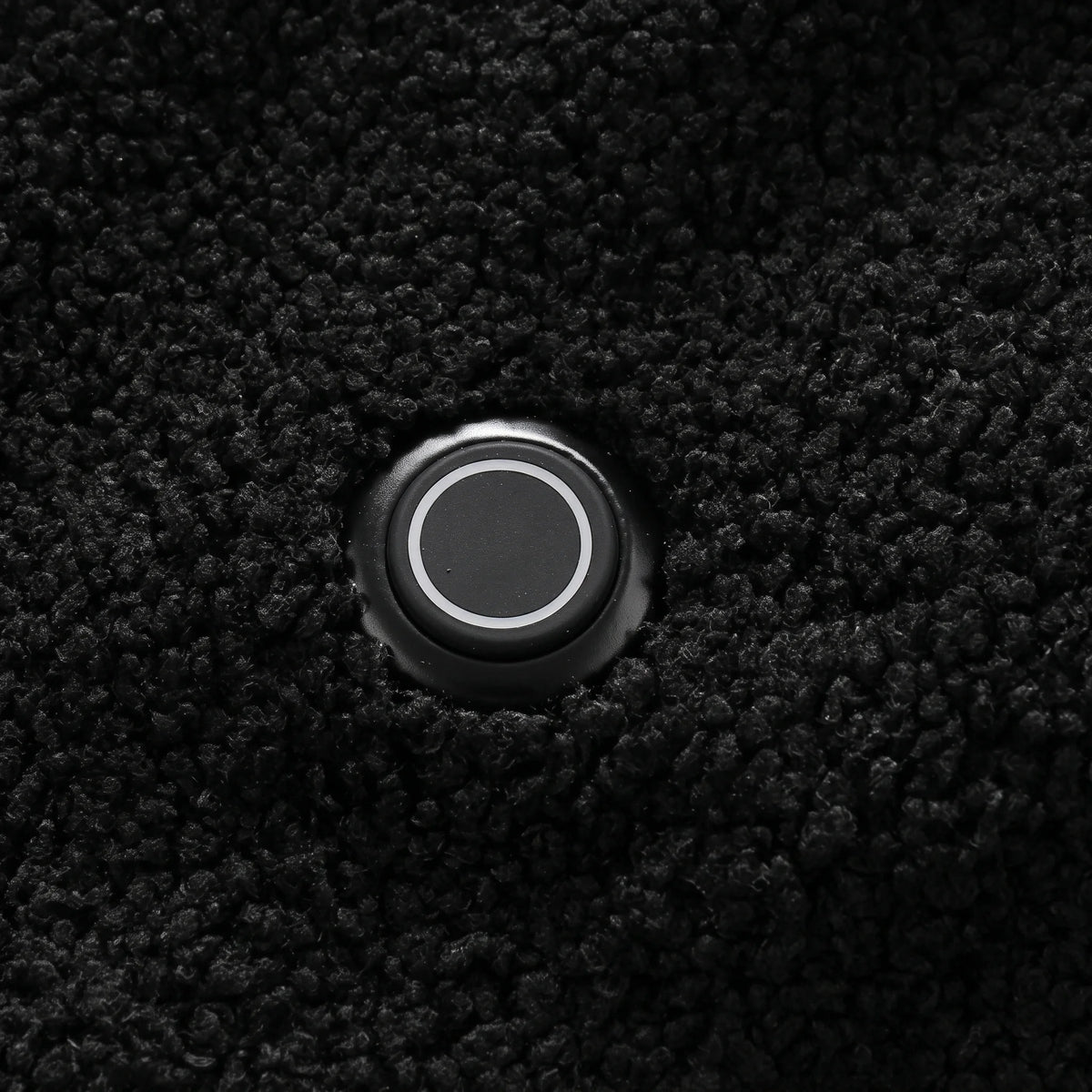 Bouton de chauffe rond et lumineux sur la poitrine du gilet