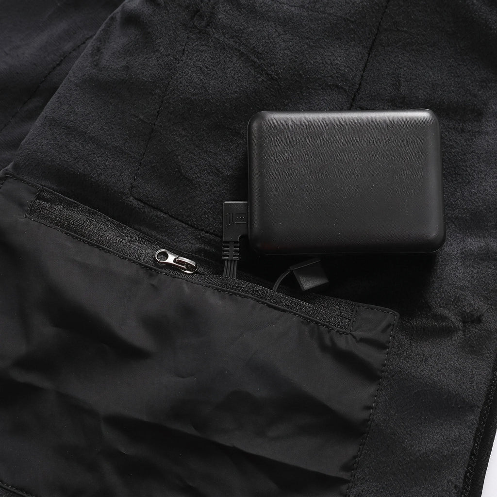 Batterie externe dans la poche intérieure zippée du gilet, batterie non incluse